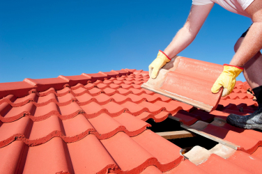 Worker laying roof